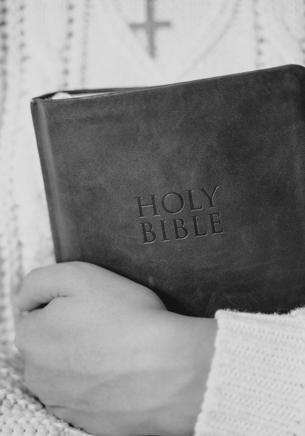 A woman holding a Bible